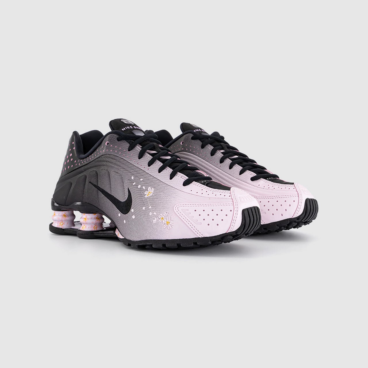 These are Nike Shox R4 sneakers in a metallic silver and black colorway